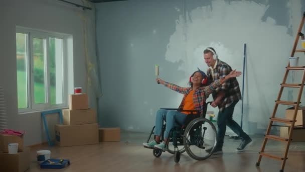 White Man Wheeling African American Woman Wheelchair Room Young Couple — Vídeos de Stock