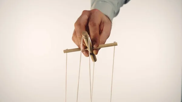 Hand Man Gray Shirt Controls Puppet Using Wooden Manipulator Strings — ストック写真