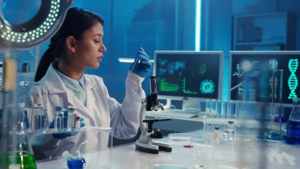 Korean Female Doctor Applies Sample Red Liquid Pipette Examines Microscope — Stock Video
