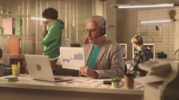 Stárnoucí Muž Komunikuje Prostřednictvím Videokonference Pomocí Notebooku Sluchátek Podnikatel Demonstruje — Stock video