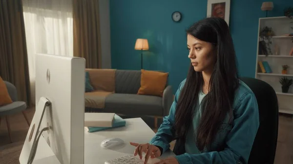 アジアの女性が居心地の良いリビングルームのコンピュータに座っています 若い女性が働いて キーボードを入力して 電子メール メッセージ チャット インターネットの閲覧 フリーランス — ストック写真