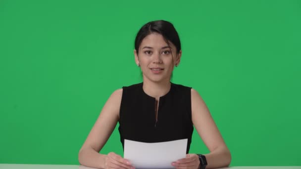 Asian Presenter Sits Table Reads Information Paper Her Hands Close — Stock Video