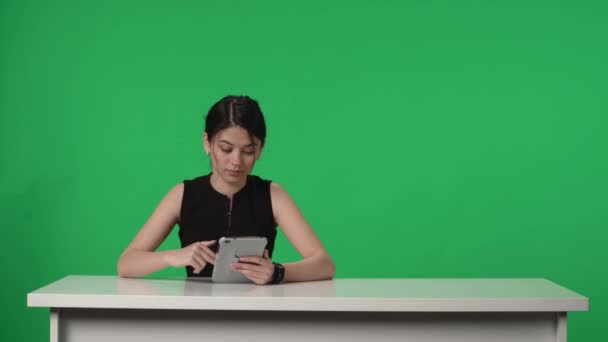 생방송 프로그램 발표자가 화면의 배경을 배경으로 스튜디오 테이블에 앉는다 여자가 — 비디오