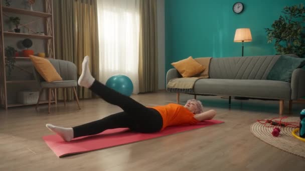 Elderly Woman Lies Sports Mat Floor Living Room Does Sports — Stock Video