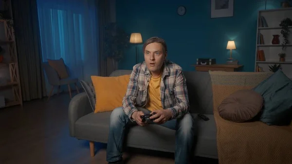 Bir Adam Akşamları Evdeki Kanepede Otururken Oyun Kontrolörüyle Konsolosluk Oyunu — Stok fotoğraf