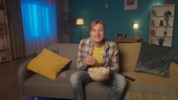 Uomo Siede Sul Divano Sera Mangia Popcorn Guarda Uomo Guarda — Video Stock