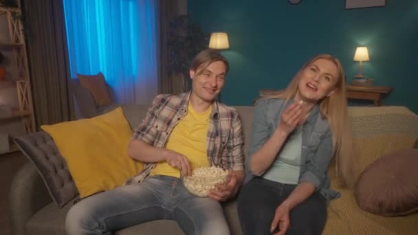 Married Couple Sits Couch Plate Popcorn Watching Movie Man Woman — Stock Video