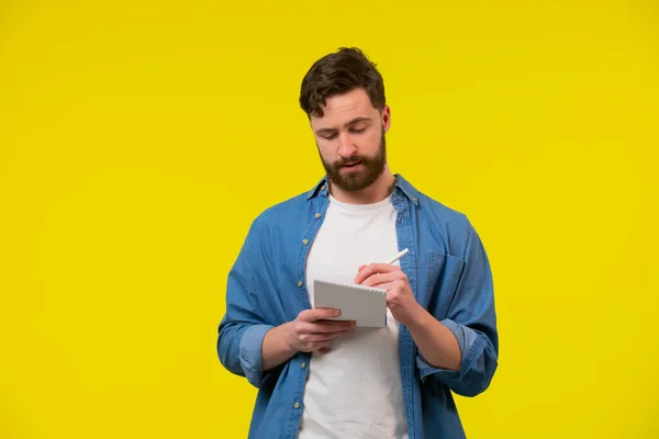 Portrait Adult Bearded Man Dressed Casually Holding Notepad Writing Something — Stock Photo, Image