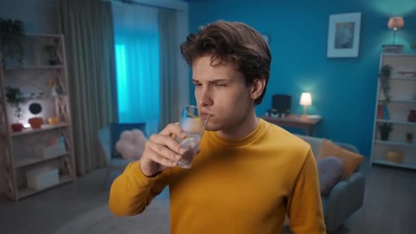 Man Drinks Ice Water While Standing Living Room Close Man — стокове відео