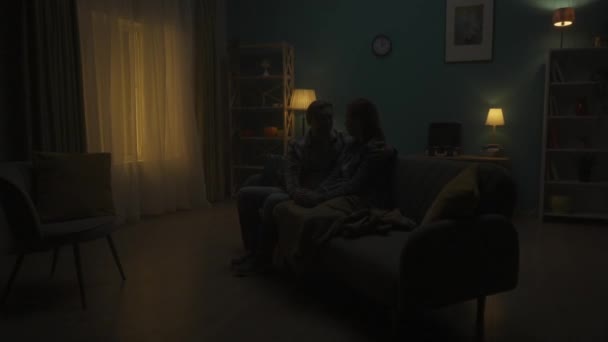 Couple Sitting Sofa Dark Room Man Listens Woman Holds Her — Stock Video