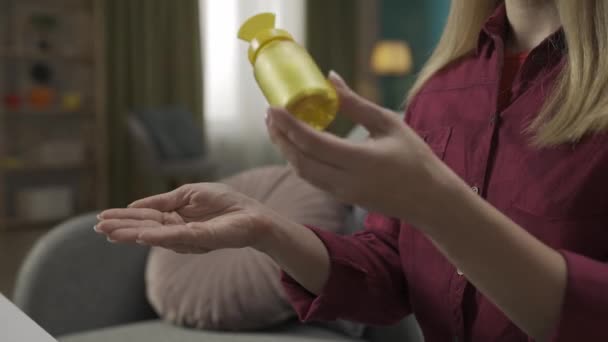 Close Shot Blonde Woman Model Sitting Sofa Holding Meds Bottle — Stock Video