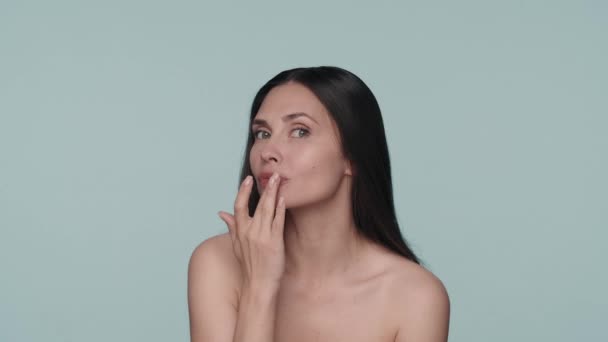 Woman Touches Her Lips While Moisturizing Them Studio Blue Background — Stock Video