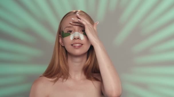 Young Woman Patches Her Eyes Plaster Blackheads Her Nose Green — Stock Video