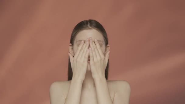 Young Seminude Woman Touches Clean Moisturized Face Studio Red Background — Stock Video