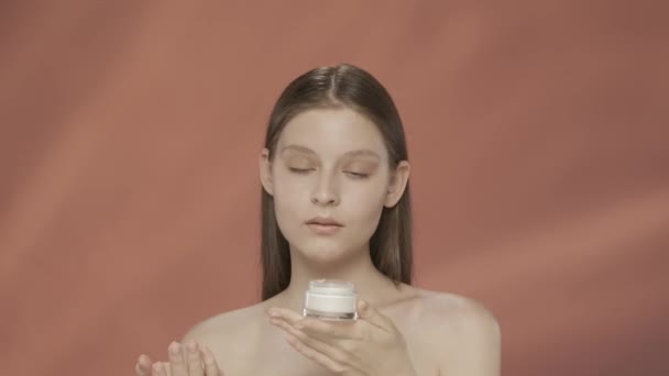 Woman Holds Jar Cosmetic Cream Inhales Its Scent Applies Cream — Stock Video