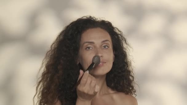 Woman Applies Powder Her Face Makeup Brush Studio Yellow Background — Stock Video