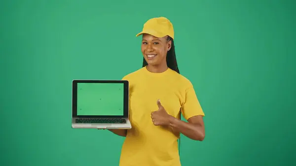 Portrait Delivery Woman Yellow Cap Tshirt Holding Laptop Showing Thumbs — Stock Photo, Image