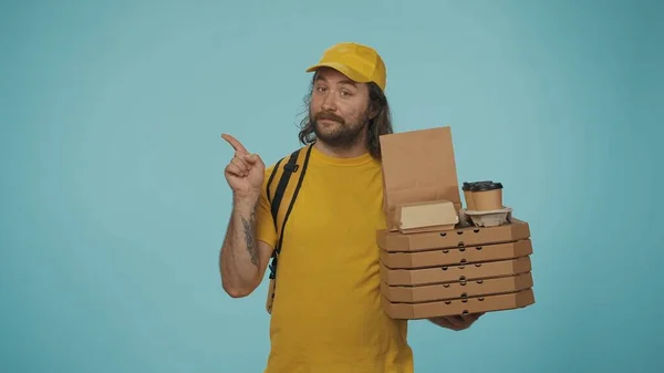 Portrait Delivery Man Yellow Cap Holding Pizza Coffee Pointing Empty — Stock Photo, Image