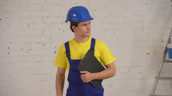 Medium Shot Construction Worker Standing Room Holding Planchette Folder His — Stock Photo, Image