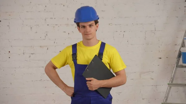 Medium Shot Construction Worker Standing Room Holding Planchette Folder His — Stock Photo, Image