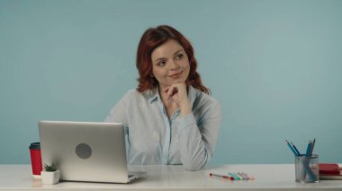 Tatmin olmuş, mutlu ve rahat genç bir kadının dizüstü bilgisayarından uzağa bakarken orta izole edilmiş görüntüsü. Barışçıl bir şekilde düşünüyor ve hayal kuruyor, eline yaslanıyor. Yaratıcı içerik.