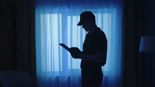 Crime Scene Creative Concept Policeman Tablet Dark Living Room Portrait — Stock Photo, Image