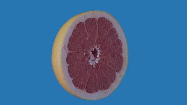 果物や野菜を健康的に食べるクリエイティブなコンセプト 着色されたスクリーンに対するフルーツ ブルーの背景に隔離されたグレープフルーツの半分を撮影したクローズアップスタジオ — ストック写真