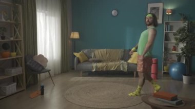 Uzun saçlı ve sakallı orta yaşlı bir ucube apartman dairesinde egzersiz yapıyor. Sporcu poz verir ve kol hareketleriyle kaslarını gösterir. Evde fitness var. Sağlıklı yaşam tarzı, vücut pozitifliği