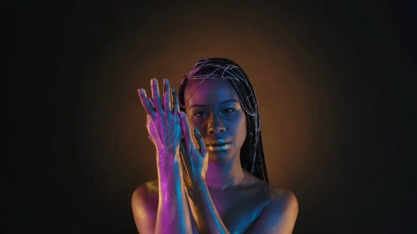 Афроамериканка Демонстрирует Свои Руки Золотой Краске Коричневом Фоне Круглым Светом — стоковое фото