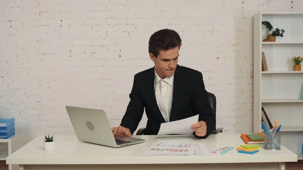 Medium Shot Young Man Sitting Office Working Laptop Cheching Graphs — Stock Photo, Image