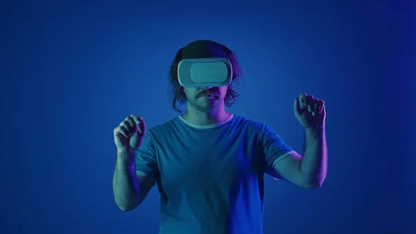 Man Wearing Virtual Glasses Scrolls Invisible Screen Man Studio Blue — Stock Photo, Image