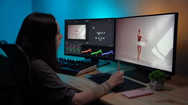 Video and photo editing advertisement concept. Freelancer working from home. Portrait of young girl in casual sitting at the desk, working on pc looking in monitors, editing ballet video.