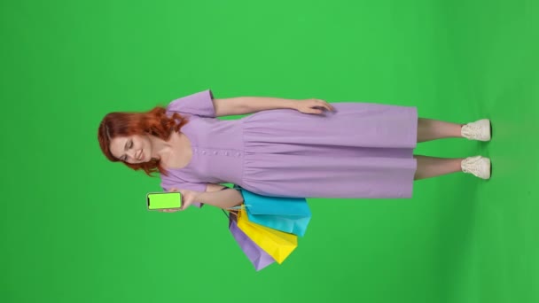 Attractive Woman Shopping Bags Points Her Index Finger Green Screen — Stock Video