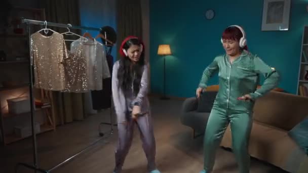 Повнорозмірне Відео Захоплює Двох Молодих Жінок Які Танцюють Кімнаті Навушниках — стокове відео