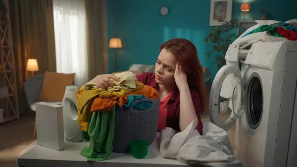 Redhead Kvinna Sitter Bredvid Tvättmaskin Tittar Tvättkorgen Frustrerad Och Utmattad — Stockfoto
