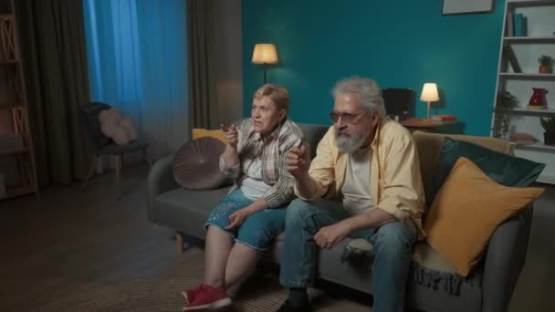 Elderly Couple Sitting Couch Room Staring Intently Somewhere Feel Excitement — Stock Video