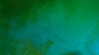 Su ve sıvı, yaratıcı ve soyut kavramları karıştırıyor. Stüdyonun su yüzeyini kapatın. Canlı neon ışıklı su yüzeyi, rüzgarla esen yeşil mürekkep girdapları, soyut arka plan. Yavaş çekim.