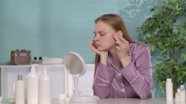 Жінка Ретельно Перевіряє Своє Обличчя Дзеркалі Сидячи Своїм Туалетним Столиком — стокове відео