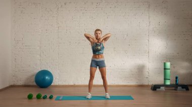 Personal sport classes at home online. Blonde female in sportswear doing exercises. Healthcare creative advertisement concept. Woman fitness coach in the room doing kettlebell pull to chest. clipart