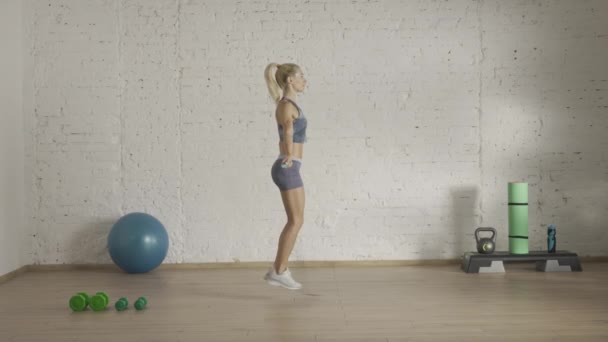 个人运动训练在家里 穿着运动服的女性做运动 保健和健康广告概念 田径女子健身教练做经典跳绳跳绳 Hdr — 图库视频影像
