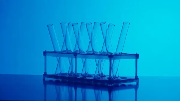 Close up photo neon blue light test tubes in a laboratory. Scientific experiment, research, study. Detail shot of lab glassware. Creative content or medical advertisement.
