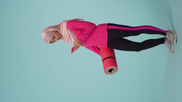 Spor Kıyafetleri Tesettür Giymiş Genç Bir Kadının Spor Paspası Tutarken — Stok video