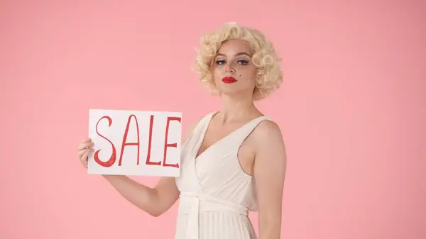 Woman Holding Poster Labeled Sale Woman Look Marilyn Monroe Studio — Stock Photo, Image