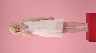 Talihsiz, sıkıntılı bir kadın şiddetli bir baş ağrısı çekerken şakaklarına masaj yapıyor. Kadın tansiyon ve migren yüzünden kendini kötü hissediyor. Marilyn Monroe 'nun görüntüsü var.