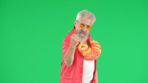 Creative modern seniors concept. Portrait of senior man hipster on Chroma key green screen background, man showing strong fist gesture looking cool at camera. Advertising area, workspace mockup.