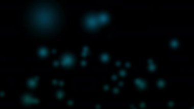 Yakın plan, siyah arka planda mavi ve parlak ışıkları gösteriyor. Yuvarlak, parlayan ve havada süzülen ışıklar gösteriyorlar. Sihirliymiş gibi davranarak sorunsuzca hareket ediyorlar..