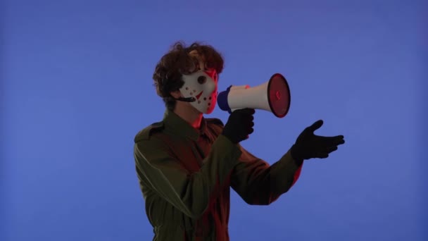 Man White Mask Loudspeaker Hands Blue Background Red Neon Light — Stock Video