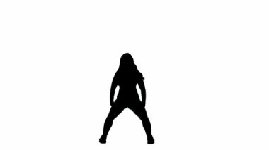 Beyaz bir arkaplanda, siluette ince bir kız duruyor. Dans hareketini twerk tarzında gösteriyor. Seksi, plastik, ritmik. Kameraya bakıyorum. Orta çerçeve. Yavaş çekim.