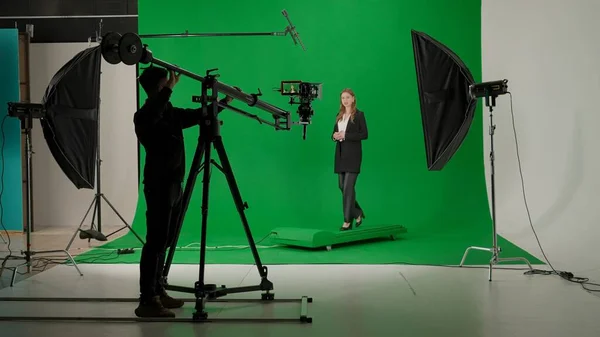 stock image News anchor at work, woman journalist presenter telling breaking news, view of a backstage studio TV news shooting, chroma key template
