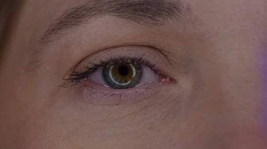 Genç bir kadının gözü makro çekim yapıyor. Cihazların uzun süre kullanılmasından dolayı büyümüş gözbebeği. Kuru göz sendromu. Sağlık, güzellik ve bakım kavramı